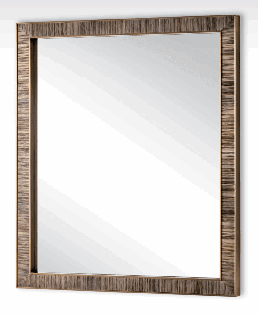 A large mirror with a textured, cast bronze frame.