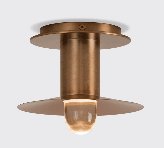 A flush mount light fixture in a warm, brushed copper finish.
