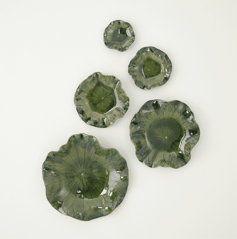 Decorative wall art shaped like water lily leaves in shades of green